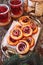 Sweet cranberry roll buns with chocolate drops and two cups of cranberry fruit drink