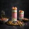 Sweet and creamy Falooda in a tall glass with sweet treats on table