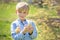 Sweet cute child, preschool boy, playing with little newborn chi