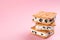 Sweet delicious ice cream cookie sandwiches on pink background. Space for text