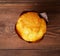 Sweet delicious muffin, on brown wooden background, top view