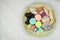 Sweet desserts in plate for the holiday. Marshmallows, macaroons, cake and chocolate candies in a large plate. Top view.