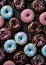 Sweet donuts in blue pink colors from top view. Assorted finest donuts