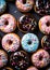 Sweet donuts in blue pink colors from top view.Assorted finest donuts