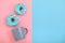 Sweet donuts pink and blue with a mug of coffee. Blue and pink background, game of colors, color conflict. Mock up for