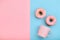 Sweet donuts pink and blue with a mug of coffee. Blue and pink background, game of colors, color conflict. Mock up for