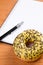 Sweet doughnut and spiral notebook