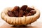 Sweet dried dates fruit in small bowl, mediterranean desert on w