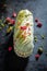 Sweet eclairs with dry pistachios and strawberries