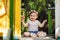 Sweet eight months old baby laughing in playground and holding her toy