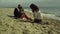 Sweet family enjoy photosession on beach sand. Parent kid posing picture by sea.