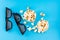 Sweet fast food. Caramel popcorn in paper cups and 3D eyeglasses on a blue background. Top view