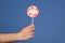 Sweet feelings. Lollipop with word love. Male hand holds lollipop with inscription love. Romantic gift for her. Gift for