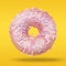 Sweet food layout made of Donut on pastel yellow and orange background. Colorful tasty Donut closeup in flying for your