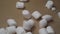 sweet food. small marshmallows are poured into a cardboard box. top view. closeup