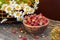 Sweet forest strawberries and a bouquet of daisies on a wooden background