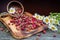 Sweet forest strawberries and a bouquet of daisies on a wooden background