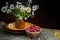 Sweet forest strawberries and a bouquet of daisies on a wooden background