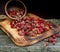 Sweet forest strawberries on a wooden background