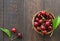 Sweet fresh cherries background. Scattered cherries on blue rustic wood pattern with copy space. Cherry fruit backround. Garden fr