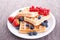 Sweet fresh tasty waffles with mixed fruits