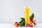 Sweet fresh yellow juice of peach and red nectarines with green leaves, juicy half cut on white wood table.