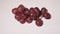 Sweet Frozen red grapes cluster on white background.