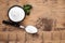 Sweet fructose powder and mint leaves on wooden table, flat lay. Space for text