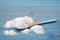 Sweet fructose powder and spoon on light blue wooden table