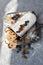 Sweet fruit cake decorated with raisins, blueberry and sugar powder icing, traditional Christstollen, stollen sliced on pieces, on