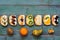 Sweet fruit sandwiches lie in a row on an old wooden green table. Fruit and sandwiches on a rustic table, top view, copy space.