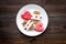 Sweet gift for St Valentine`s Day. Heart shaped gingerbread on dark wooden background top view copy space