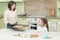 Sweet girl baking cookies with her mother