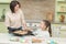 Sweet girl baking cookies with her mother