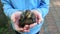 A sweet girl is holding a small thrush.