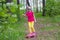 Sweet girl learns to ride a skateboard in the park