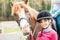 A sweet girl riding a white horse, an athlete engaged in equestrian sports, a girl hugs and kisses a horse.