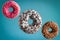 Sweet  glazed donuts flying over blue background