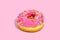 Sweet glazed pink doughnut isolated on colorful background