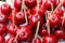 Sweet glazed red toffee candy apples on sticks for sale on farmer market or country fair