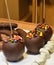 Sweet glazed red toffee candy apples on sticks for sale on farmer market or country fair