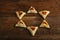 Sweet gometashi cookies for Purim laid out on a wooden table in the form of Magen David.