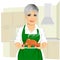 Sweet grandmother in green apron cooking traditional thanksgiving turkey