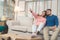 Sweet happy young Asian couple moving clothes and many objects from old home to their new home and relax on sofa in living room.