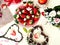 Sweet hearts Strawberry  and slices  on white background ,table setting ,flowers in red cup ,and ,branch in heart shape still life