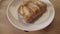 Sweet homemade glazed buns with apples on wooden surface background. Stock footage. Close up of tasty baked pastry good