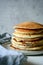 Sweet Homemade Stack of Pancakes with honey for Breakfast on a gray background. Sweet beautiful breakfast. Brunch.