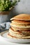 Sweet Homemade Stack of Pancakes with honey for Breakfast on a gray background. Sweet beautiful breakfast. Brunch.