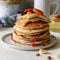 Sweet Homemade Stack of Pancakes with honey for Breakfast on a gray background. Sweet beautiful breakfast. Brunch.