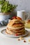 Sweet Homemade Stack of Pancakes with honey for Breakfast on a gray background. Sweet beautiful breakfast. Brunch.